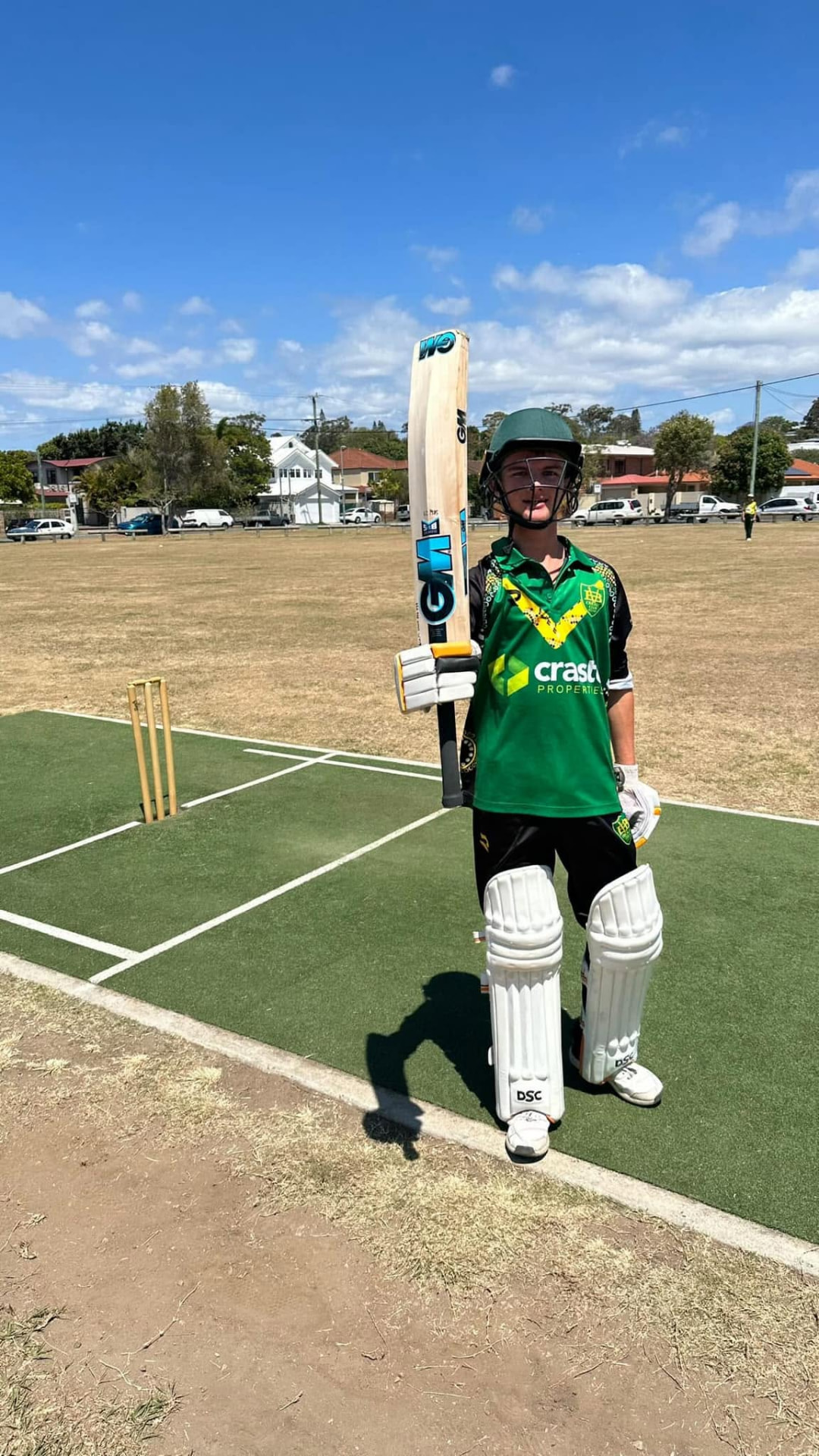 Young batter raising his bat after a milestone