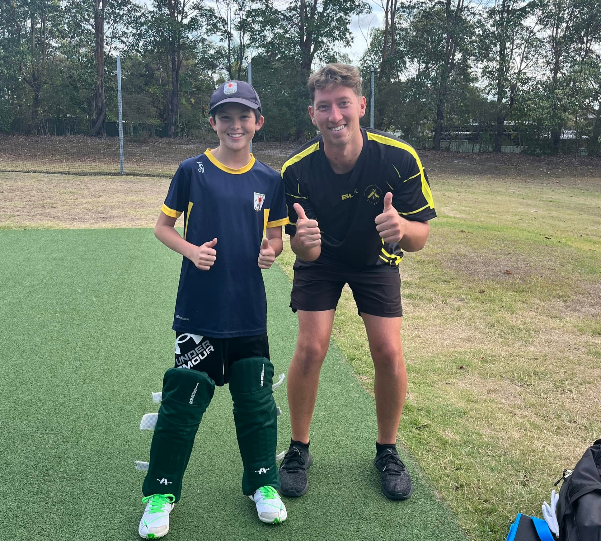 Jarrod and a young player giving thumbs up on the pitch